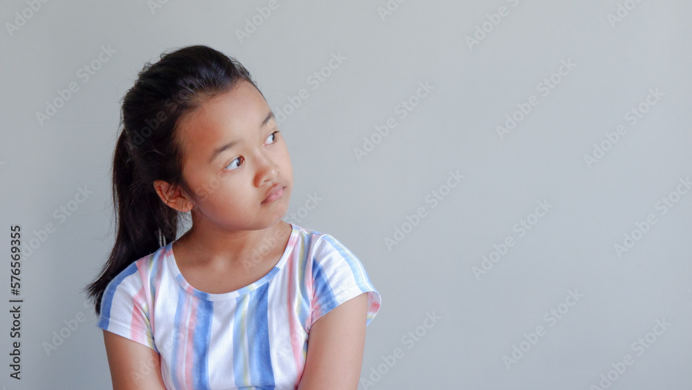 Cute asian child girl wearing casual outfit smiling looking to the side and staring away thinking. Cute asian child girl wearing casual outfit smiling looking to the side and staring away thinking.