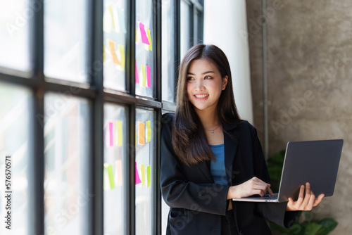 Portrait of Business woman analytic finance statistics and planning strategy by laptop. tax  report  accounting concept