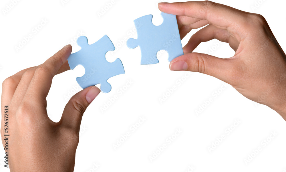 Closeup on Hands Combining Puzzle Pieces Together Closeup on Hands Combining Puzzle Pieces Together