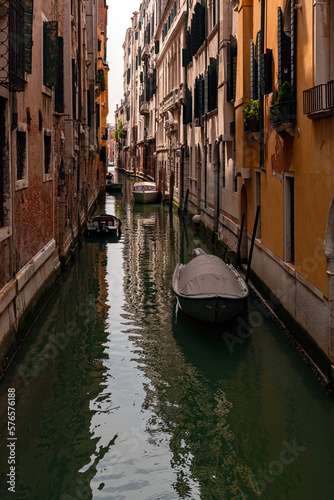 A canal in venice with a bridge and a boat on it © Andrey