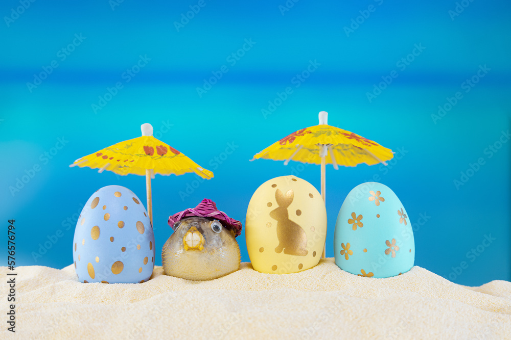 Happy easter. Yellow and blue eggs with puffer fish under