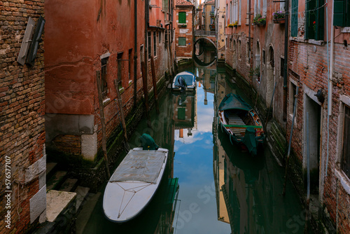 A canal in venice with a bridge and a boat on it © Andrey