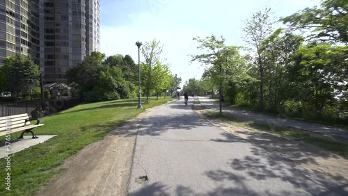 Wallpaper Mural Cyclist biking on a path in sunny downtown Toronto in summer. Torontodigital.ca