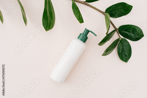 Natural home cosmetics in recyclable plastic bottles and cans on a beige background. Flat lay