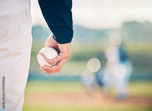 Baseball player, ball and athlete or pitcher hand in a competitive match or game on the sports field for training. Closeup, sportsman and person playing a sport or softball as exercise and fitness photo