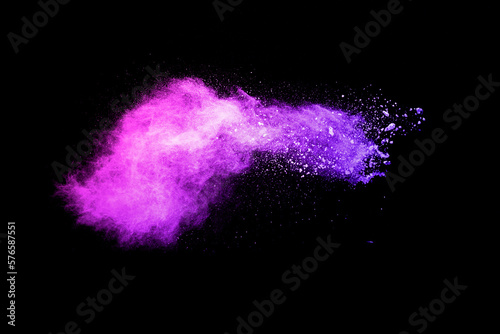 Purple color powder explosion cloud on black background.Purple dust particles splash.