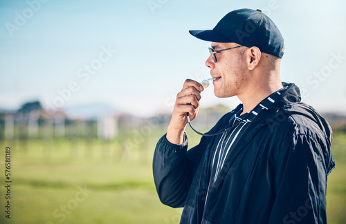 Coach, blowing whistle and sports training on a field with a man outdoor for competition or challenge. Fitness trainer or teacher person on grass for athlete game, coaching and pitch time strategy