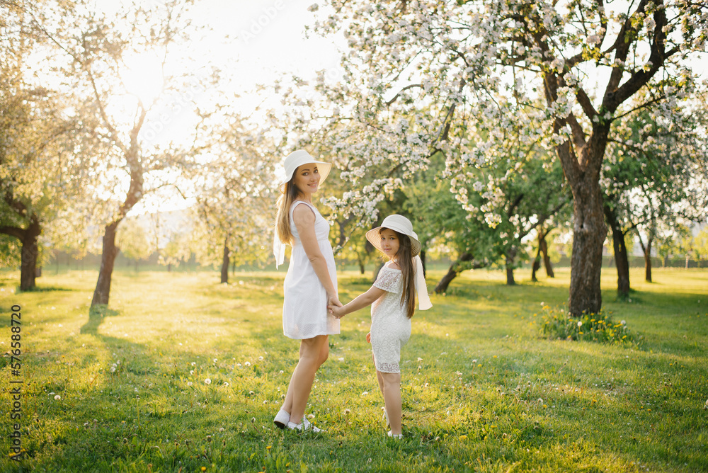 Happy mom family with their beautiful daughter outdoors