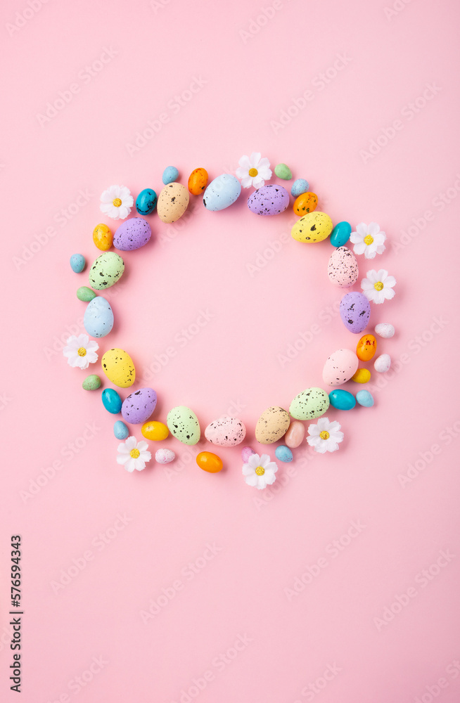 Easter Eggs with Sweets and Spring Flowers on Pink Background Easter Eggs with Sweets and Spring Flowers on Pink Background