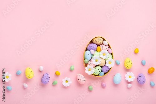 Easter Eggs with Sweets and Spring Flowers on Pink Background © Iuliia Metkalova
