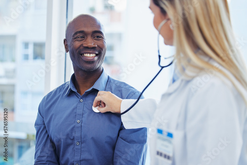 Patient, doctor woman and consultation with stethoscope in hospital for cardiology or health insurance. Black man and healthcare person talking about lungs, breathing and advice for healthy heart