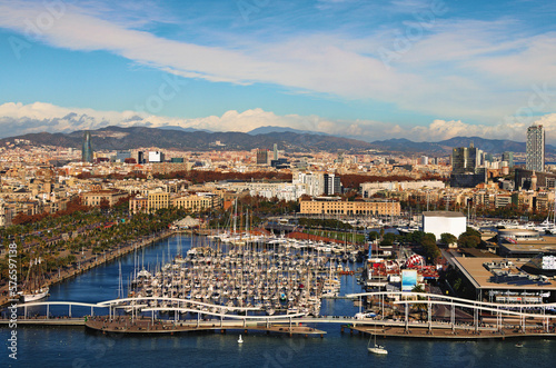 Amazing aerial landscape of historic part of Barcelona during sunny day. Embankment, harbor with moored yachts on the foreground. View from the cable car. Travel and tourism concept © evgenij84