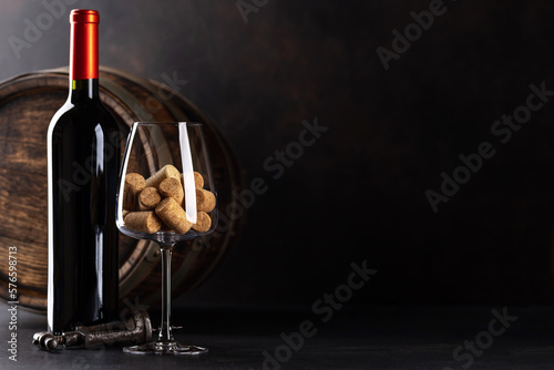 Red wine bottle, barrel and wine glass with corks