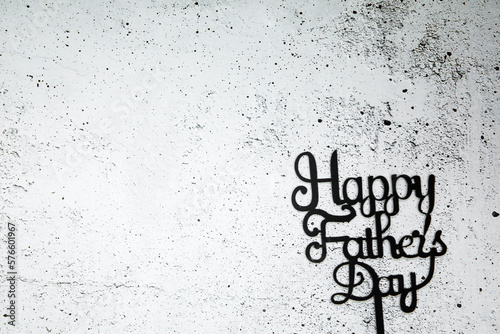 Happy Fathers Day concept. Black Letters with text Happy Father's Day on concrete white black background Flat lay, top view, copy space