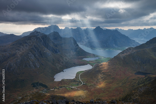 Rays of light shine over lake Storvatnet from Stornappstind, FlakstadÃ¸y, Lofoten Islands, Norway photo