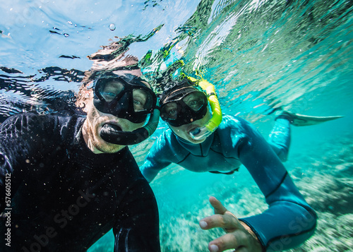 Two people snorkeling underwater photo