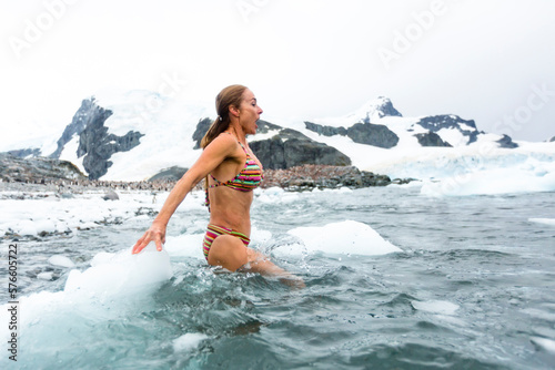 Woman in bikini in sea, Cuverville Island, Antarctic Peninsula photo