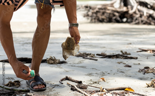 hand of man cleaning on the beach, Earth day and Environment concept