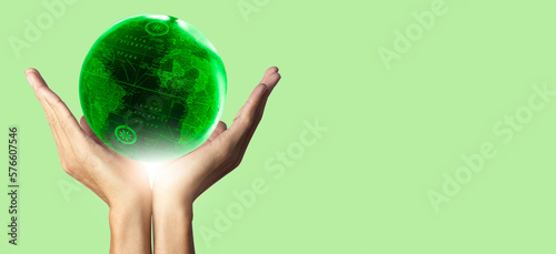 hand holding green earth and soft green background, Earth day and environment concept