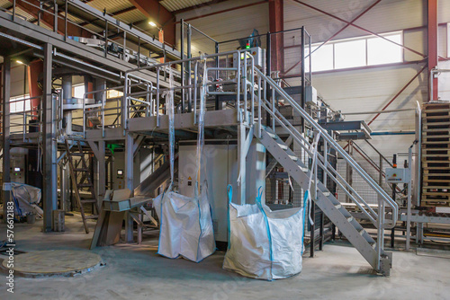 Factory workshop with bags on the conveyor line.