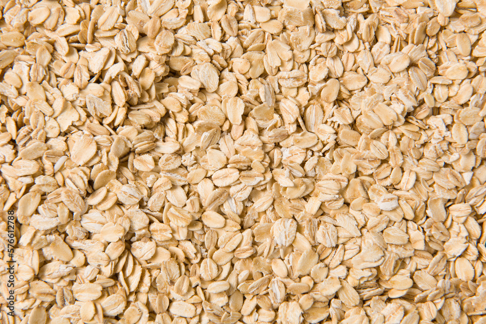 Rolled oat, oat flakes background or texture.