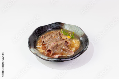 Wagyu Beef Porridge Thai style boiled rice topped with sliced ​​Wagyu beef on a white background 