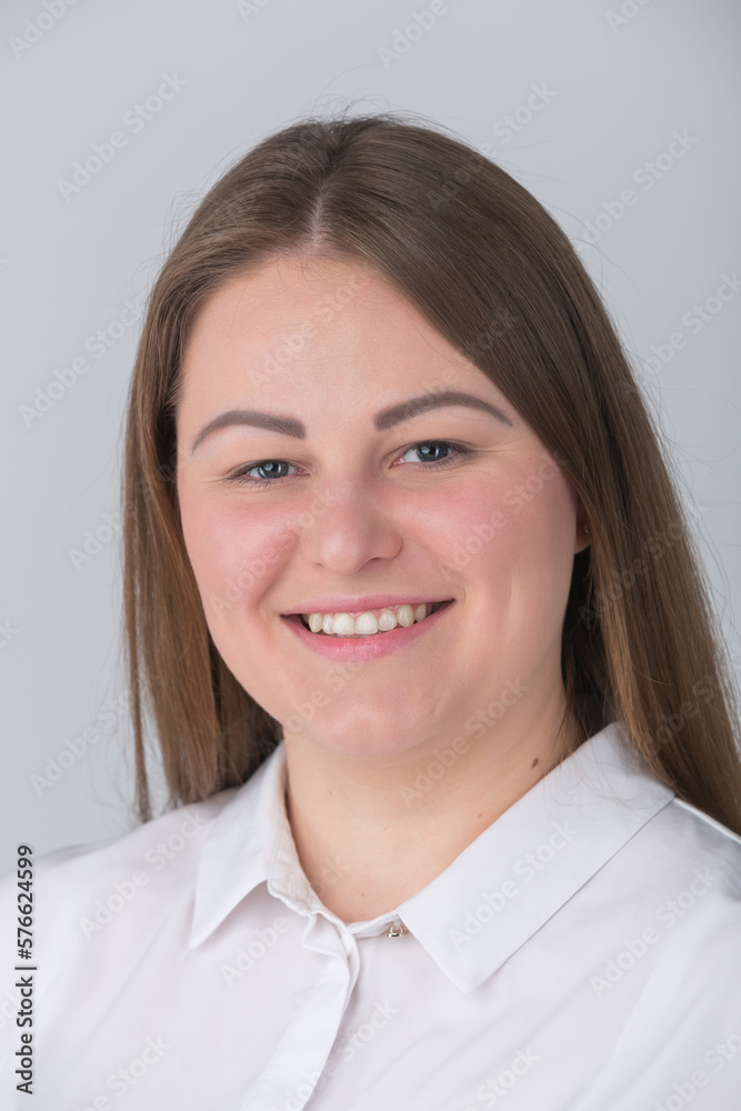 Portrait of happy plus size woman. Beautiful young overweight female person posing for formal head shot photo in the studio Portrait of happy plus size woman. Beautiful young overweight female person posing for formal head shot photo in the studio