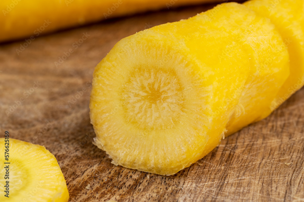 Sliced bright yellow carrots on the table Sliced bright yellow carrots on the table