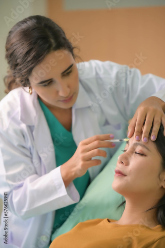 Asian beautiful woman consulting about Cosmetic surgeon and make Botox injections on face for beauty procedures. Plastic surgery in face of woman