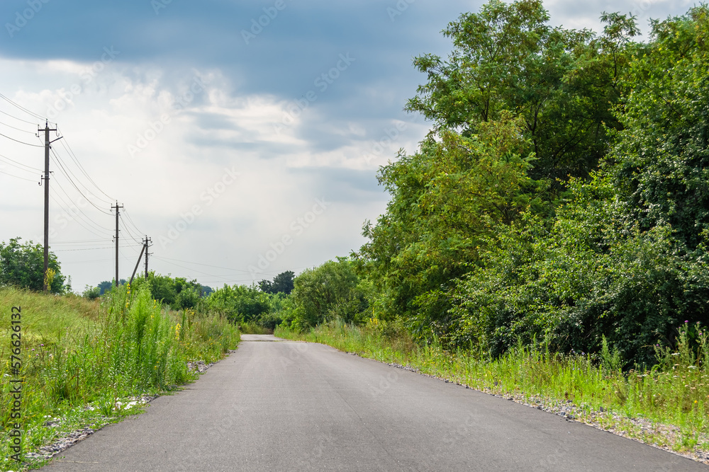 Beautiful empty asphalt road in countryside on colored background