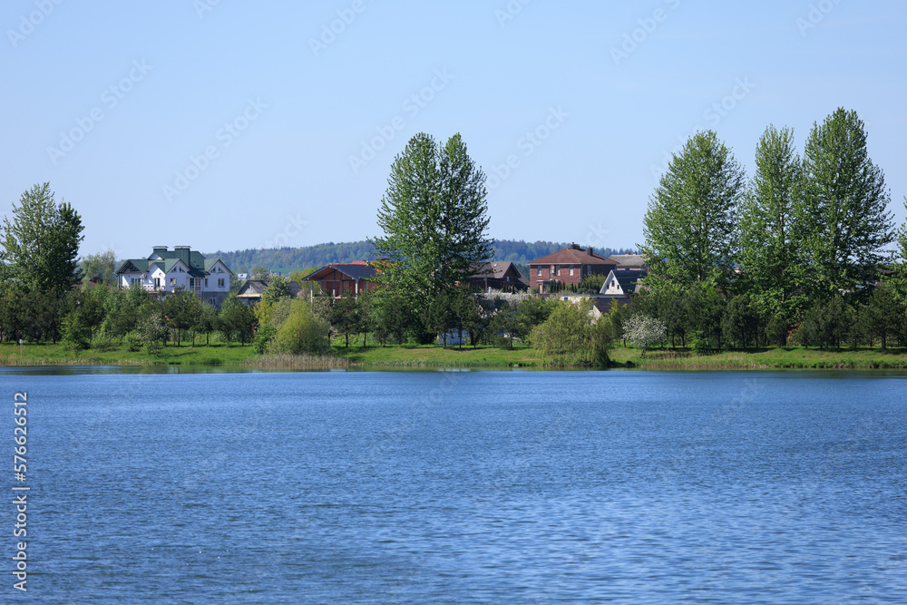 Buildings and houses standing on the shore of a lake, river or sea. 