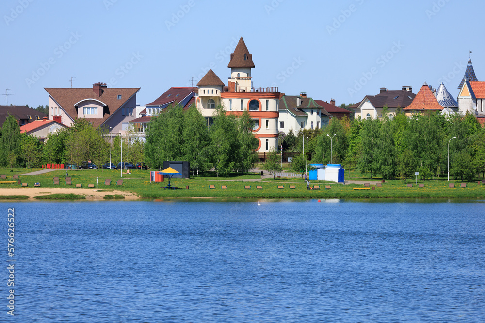 Fototapeta premium Buildings and houses standing on the shore of a lake, river or sea. 