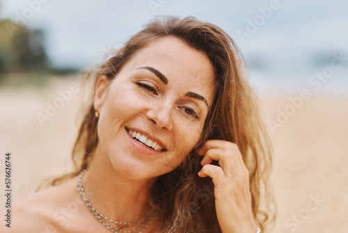 Young adorable happy woman is playing and relaxing on ocean water on at Thailand beach