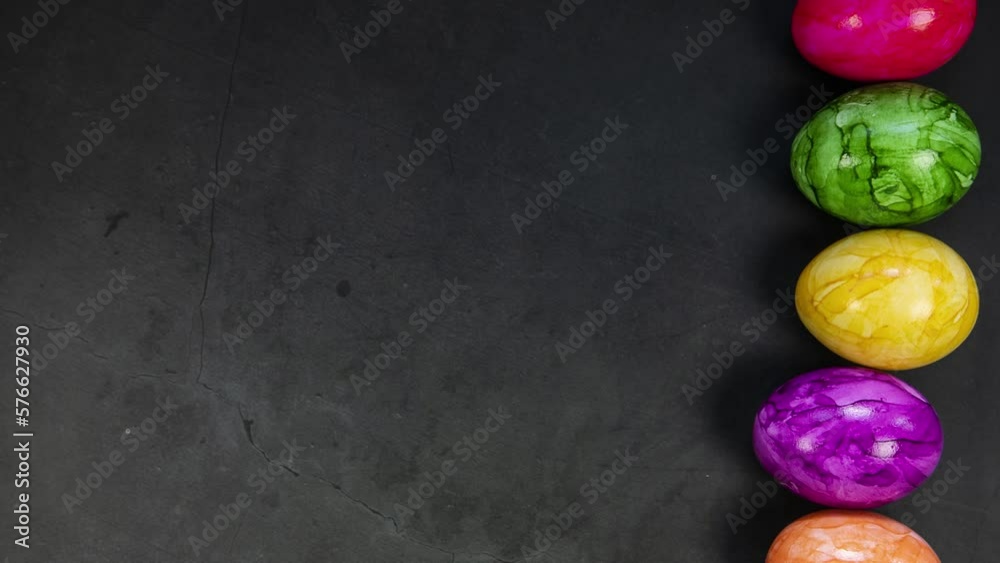 Easter eggs colorful moving on concrete background, top view from left to right, Happy Easter concept with copy space Easter eggs colorful moving on concrete background, top view from left to right, Happy Easter concept with copy space