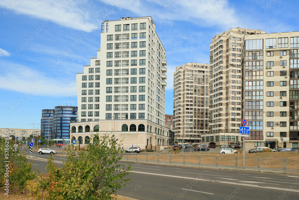 City view on a sunny day. Modern houses against the blue sky. City view on a sunny day. Modern houses against the blue sky.