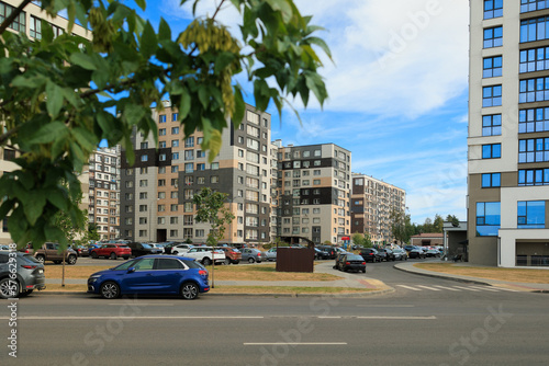 City view on a sunny day. Modern houses against the blue sky. © Kozlik_mozlik