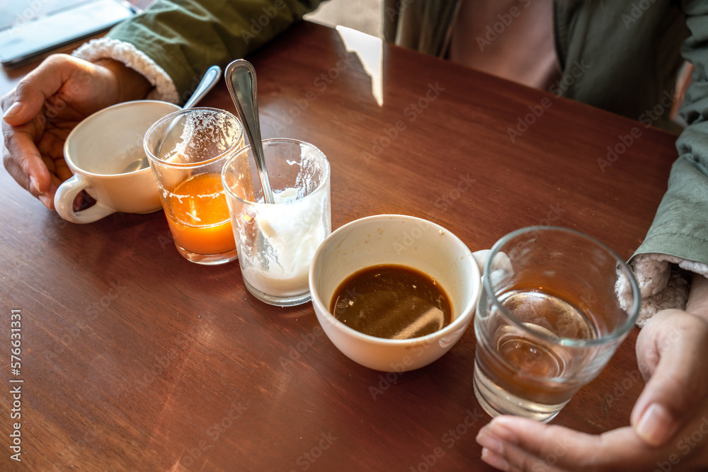 Scrap of food in the white Cup after Drink. Different cups of coffee on wooden table, top view Scrap of food in the white Cup after Drink. Different cups of coffee on wooden table, top view