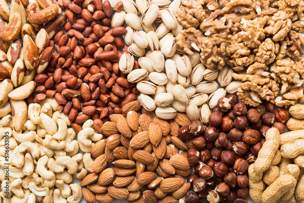 different nuts background. Close up, top view, flat lay. Walnut, pistachios, almonds, hazelnuts and cashews different nuts background. Close up, top view, flat lay. Walnut, pistachios, almonds, hazelnuts and cashews