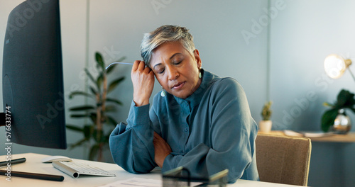 Photos Stress, headache and burnout with a business woman suffering from anxiety while working in her office