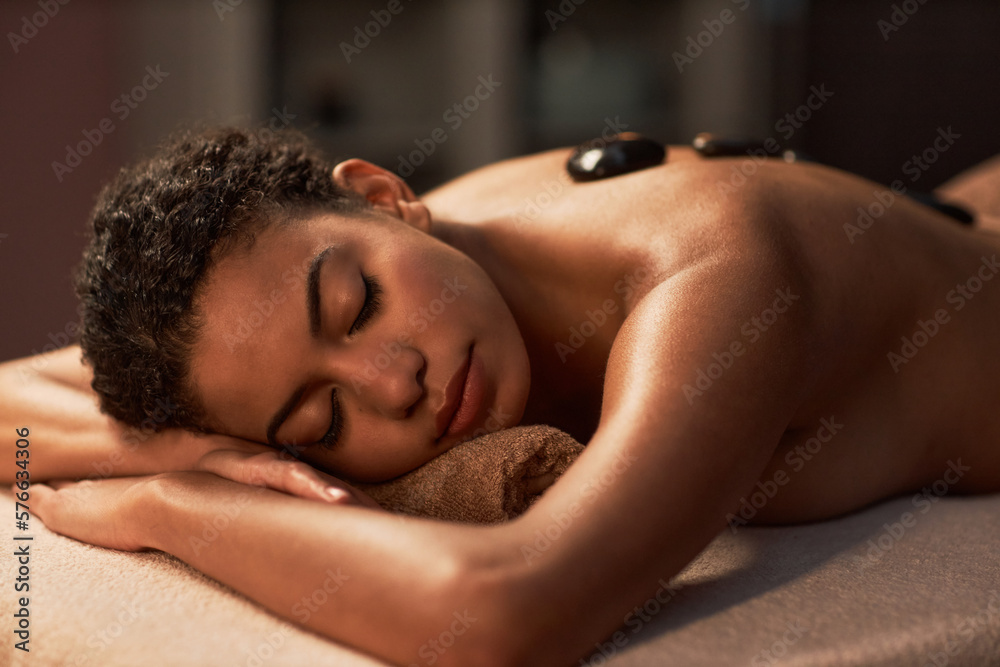 Young woman fell asleep when getting hot stones spa procedure Young woman fell asleep when getting hot stones spa procedure