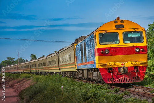 Passenger train by diesel locomotive passed the railway curve. 