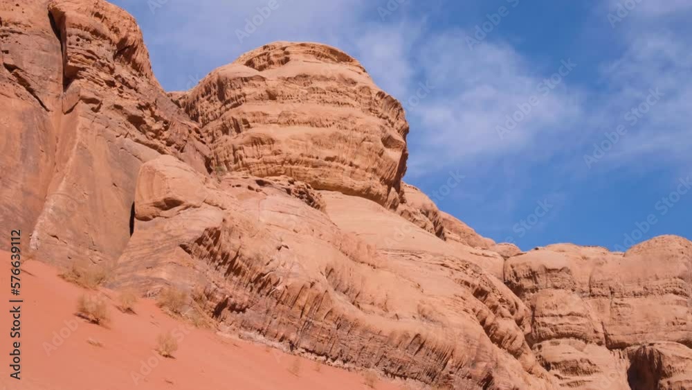 Wild and rugged red sandstone mountain landscape against blue sky in the desert of Wadi Rum, Jordan, Middle East Wild and rugged red sandstone mountain landscape against blue sky in the desert of Wadi Rum, Jordan, Middle East