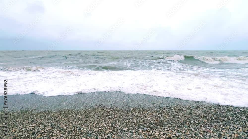 Powerful sea waves are crashing on the Black Sea coast. Waves splash on the beach with pebbles during a storm. Storm at sea. Panoramic view of the Black Sea. Russia. Sunset on the beach. 4K Powerful sea waves are crashing on the Black Sea coast. Waves splash on the beach with pebbles during a storm. Storm at sea. Panoramic view of the Black Sea. Russia. Sunset on the beach. 4K