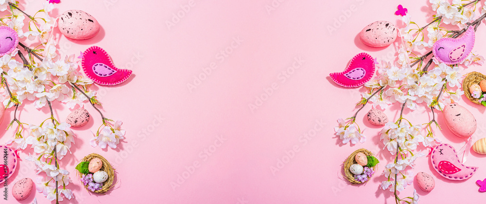 Fototapeta premium Gentle Easter composition with cherry flowers and handmade felt birds. Decorative eggs and nest