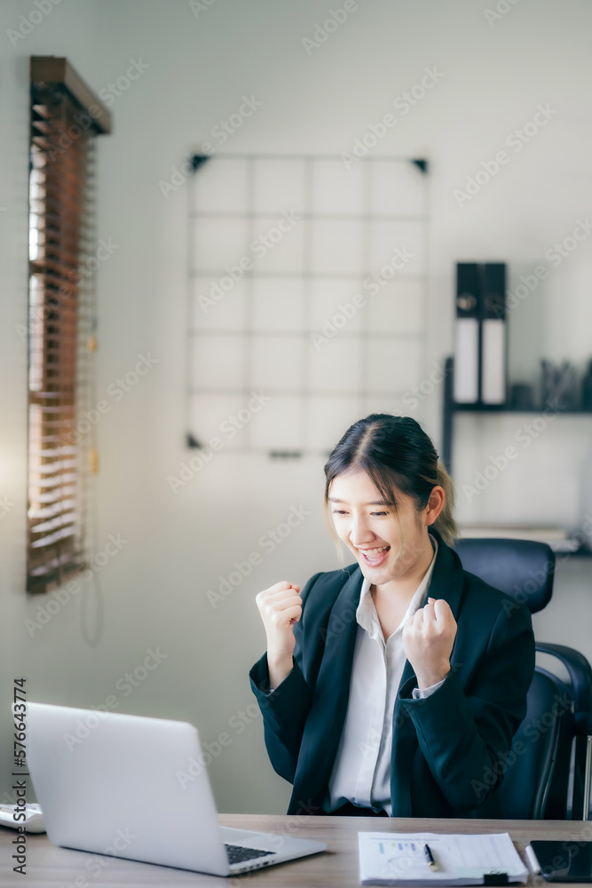 Asian business woman are excited business success with inspiration from their excellent financial results that are happy working in a modern office on a computer. Asian business woman are excited business success with inspiration from their excellent financial results that are happy working in a modern office on a computer.