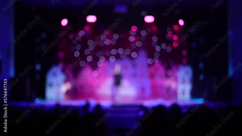 Blur defocus texture, background for design. Singers and musicians perform on scene. Blur defocus texture, background for design. Singers and musicians perform on scene.