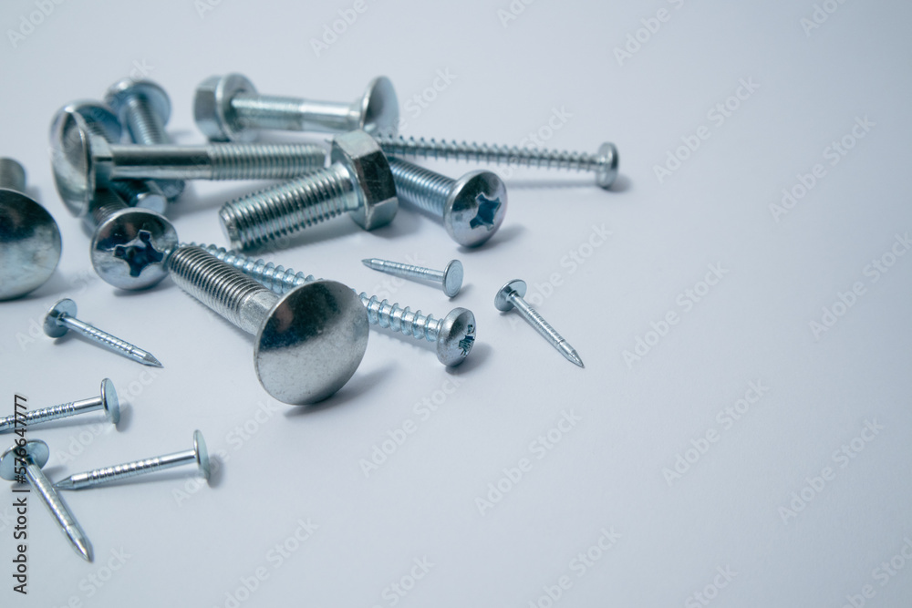 Set of bolts, screws, nails on a white background. Construction abstraction. Industrial background. Screws and bolts macro photo, screw background, steel screw, bolt macro. Set of bolts, screws, nails on a white background. Construction abstraction. Industrial background. Screws and bolts macro photo, screw background, steel screw, bolt macro.