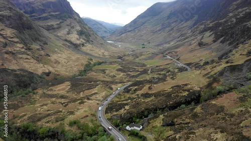 Aerial view of a valley in the Highlands with a road that winds through the mountains