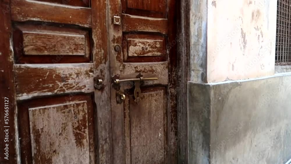 Old wooden door in Mji Mkongwe, Zanzibar. Typical house entrance, handheld Old wooden door in Mji Mkongwe, Zanzibar. Typical house entrance, handheld