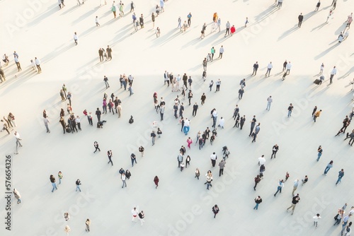 Fototapeta Group of people gather and walk in the city, aerial view of a crowd